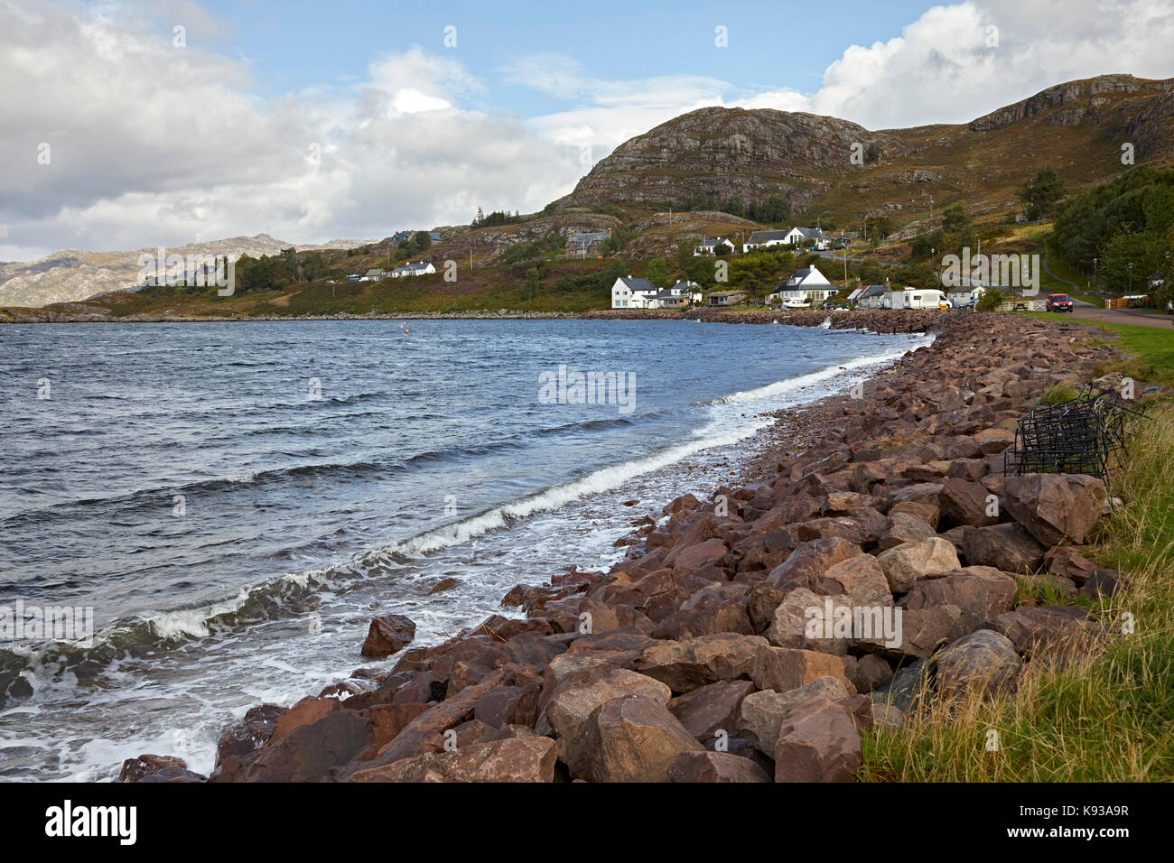 Looking north from Shieldaig across Loch Shieldaig showing rocky sea defences and shore line. Ross and Cromarty, Scotland Stock Photo