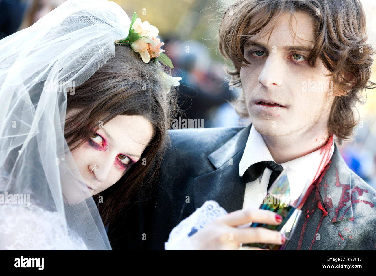 Two people, male and female, dressed as a zombie bride and groom at a zombie wedding Stock Photo