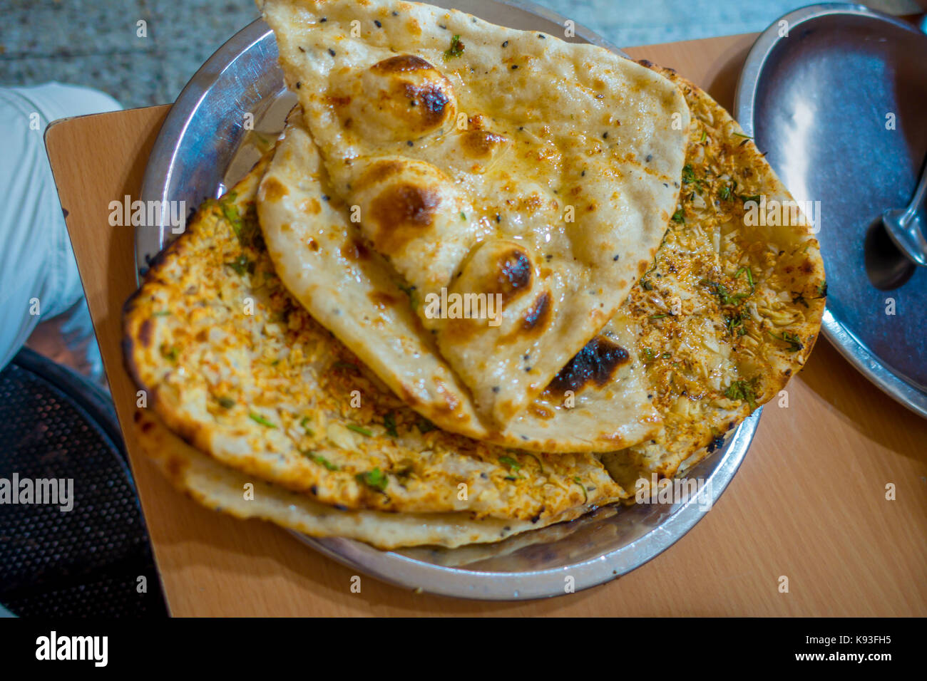 Many homemade small tortillas for breakfast, in silver foil, Jaipur city in India Stock Photo