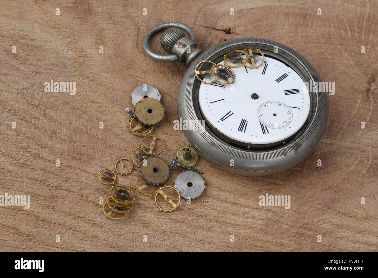 broken vintage pocket watch on wooden background Stock Photo Alamy