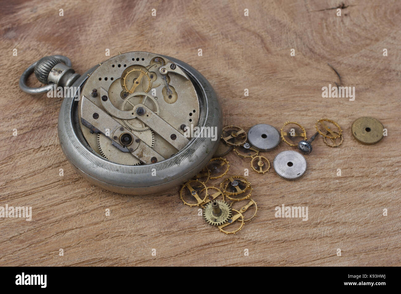 broken vintage pocket watch on wooden background Stock Photo Alamy