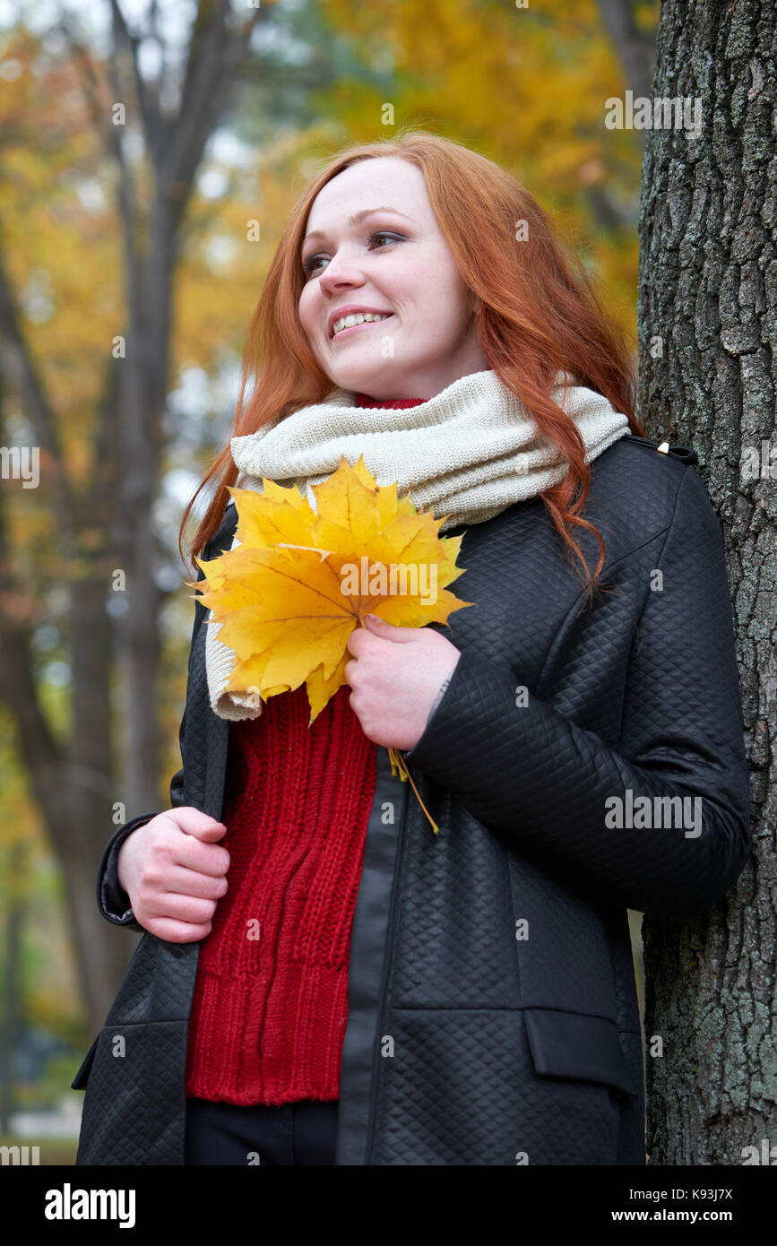 young woman stand near tree in autumn park, yellow leaves Stock Photo ...