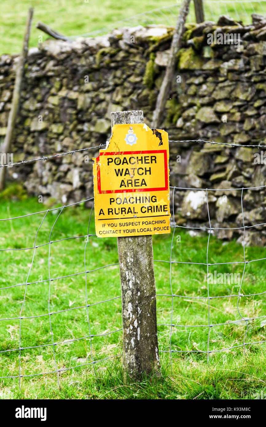 A sign saying poacher watch area, poaching a rural crime, England, UK