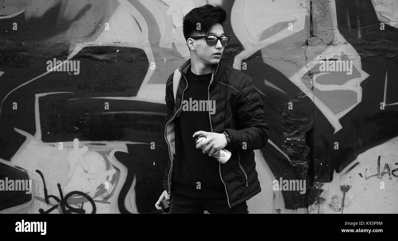Black White photo of Asian young man outdoors posing Stock Photo - Alamy