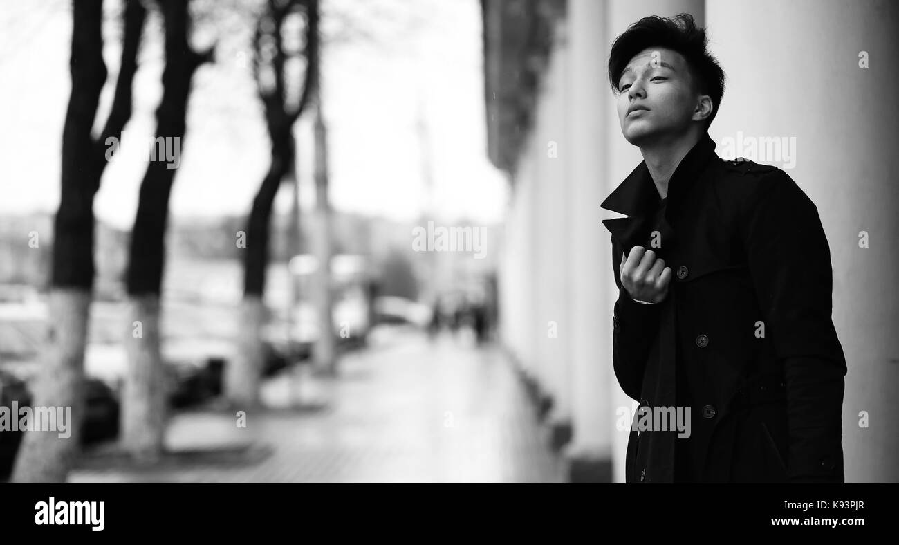 Black White photo of Asian young man outdoors posing Stock Photo - Alamy