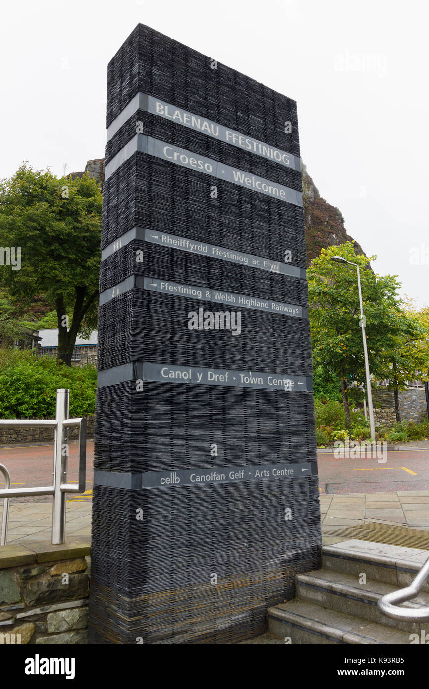 Street sign giving directions made out of slate in the historic Welsh mining town of Blaenau Ffestiniog in English and Welsh languages Stock Photo