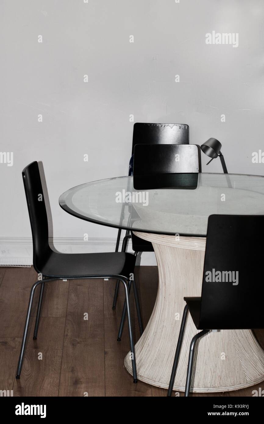 Big Table With Glass Cover And Black Chairs In Living Room