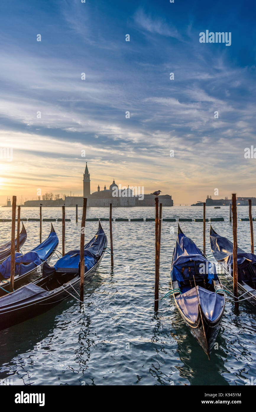 Gondolas moored on a canal in Venice, Italy, at sunrise Stock Photo - Alamy