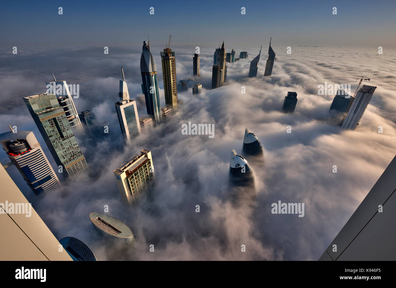Aerial view of cityscape with skyscrapers above the clouds in Dubai