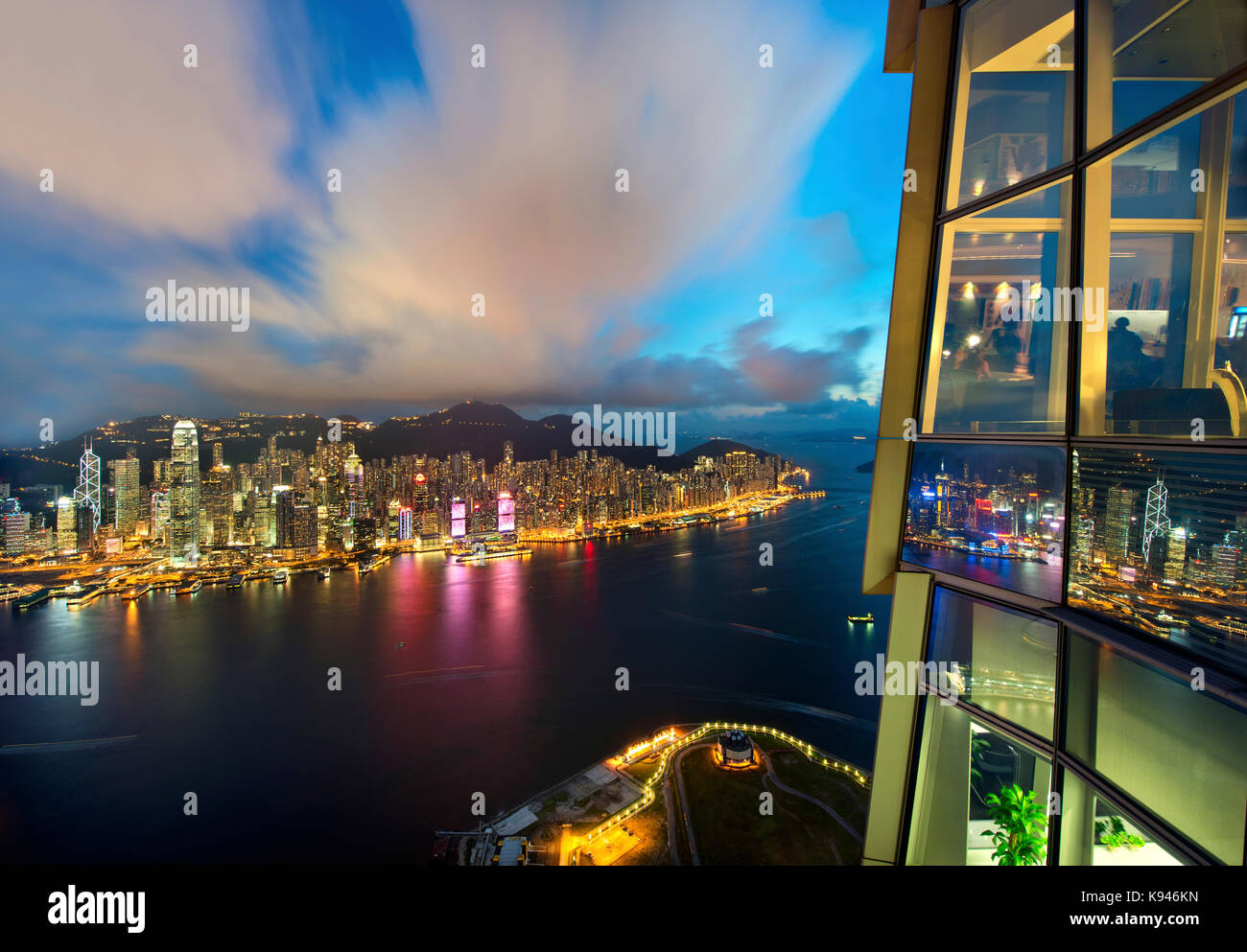 Aerial view of Hong Kong cityscape with illuminated skyscrapers at dusk ...