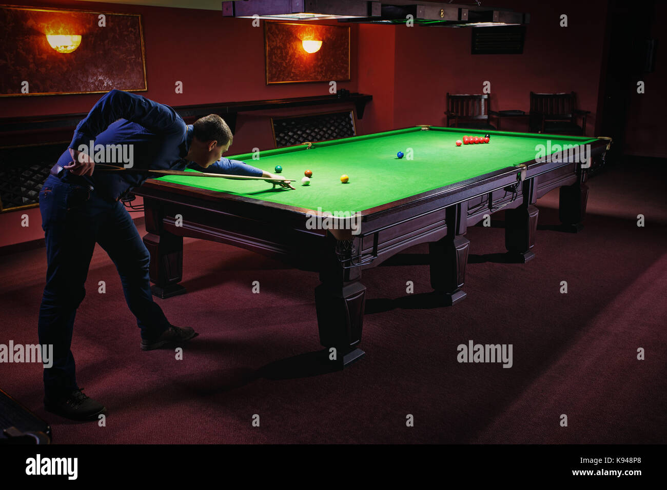 Playing pool, man aiming the billiard ball Stock Photo Alamy
