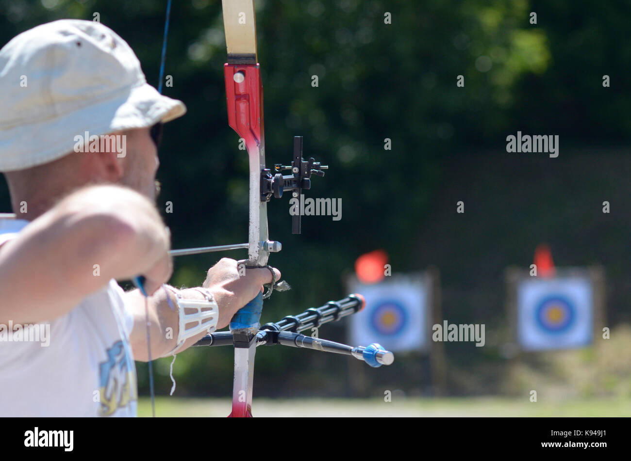 An archers aiming at archery target on a shooting range for archery. Stock Photo