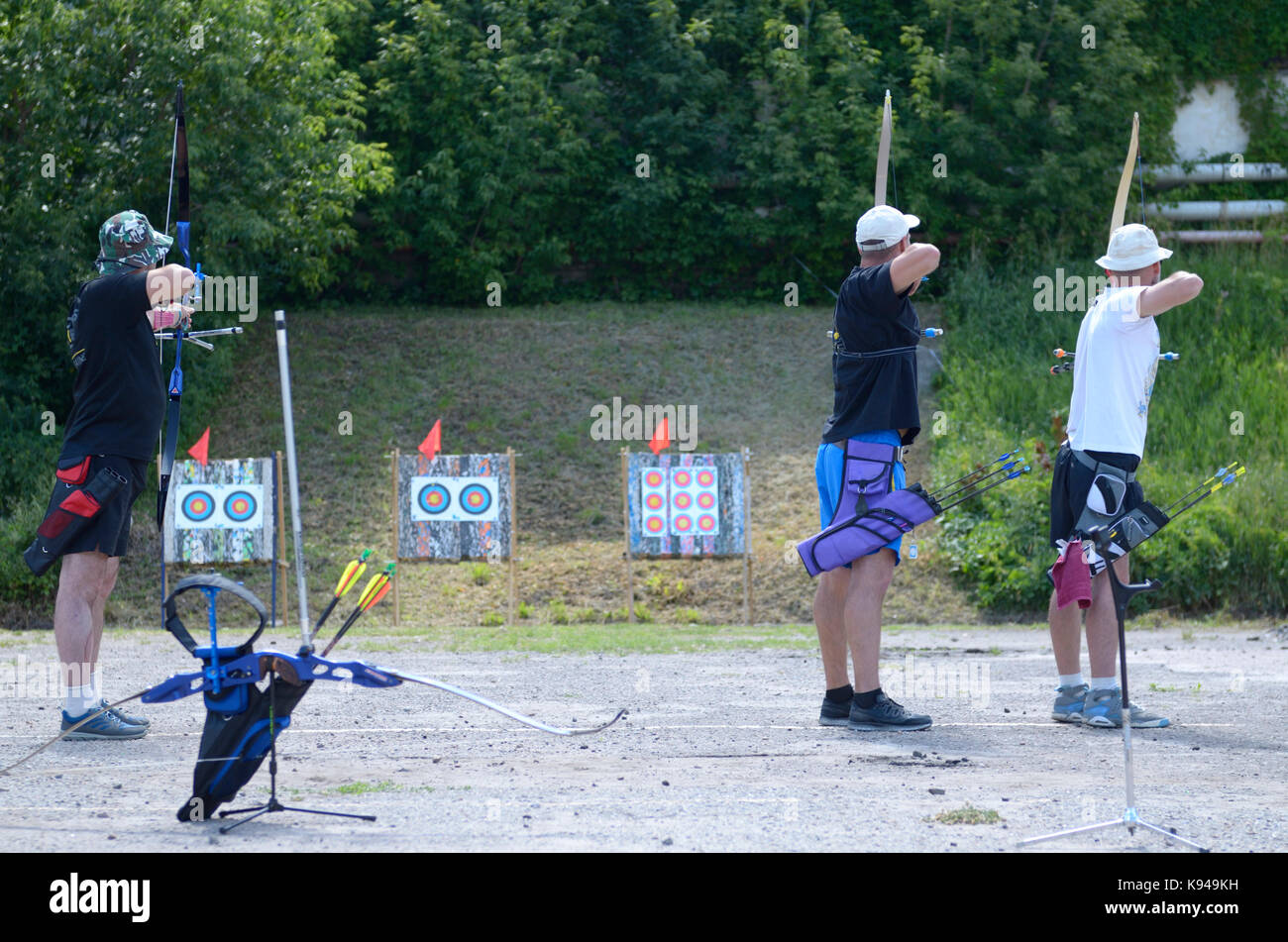 An archers aiming at archery target on a shooting range for archery