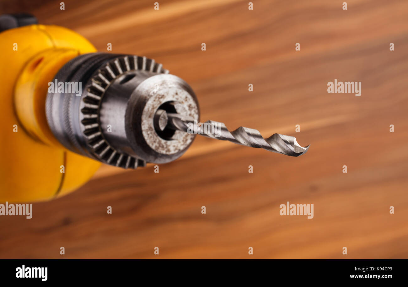drill on a wooden background. Stock Photo