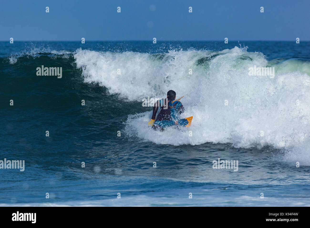 DEAL, NEW JERSEY - September 16, 2017: A bodyboarder enjoys surfing the rough surf created by Tropical Storm Jose Stock Photo