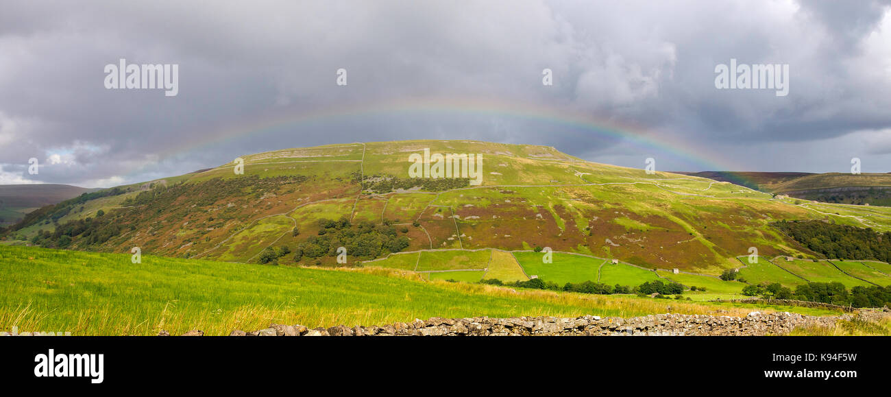 A Beautiful Rainbow Curves Over Remote Moorland in Swaledale near Muker Yorkshire Dales National Park Yorkshire England United Kingdom UK Stock Photo
