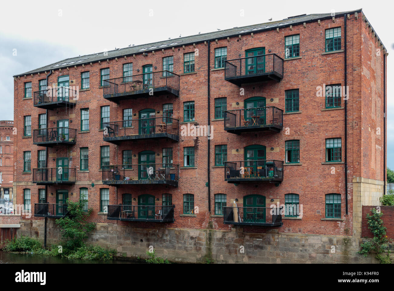 Canal side industrial building refurbished into flats, Leeds city