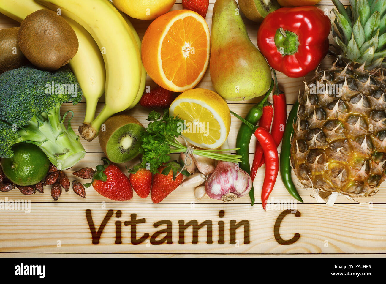 Vitamin C in fruits and vegetables. Natural products rich in vitamin C as oranges, lemons, dried fruits rose, red pepper, kiwi, parsley leaves, garlic Stock Photo