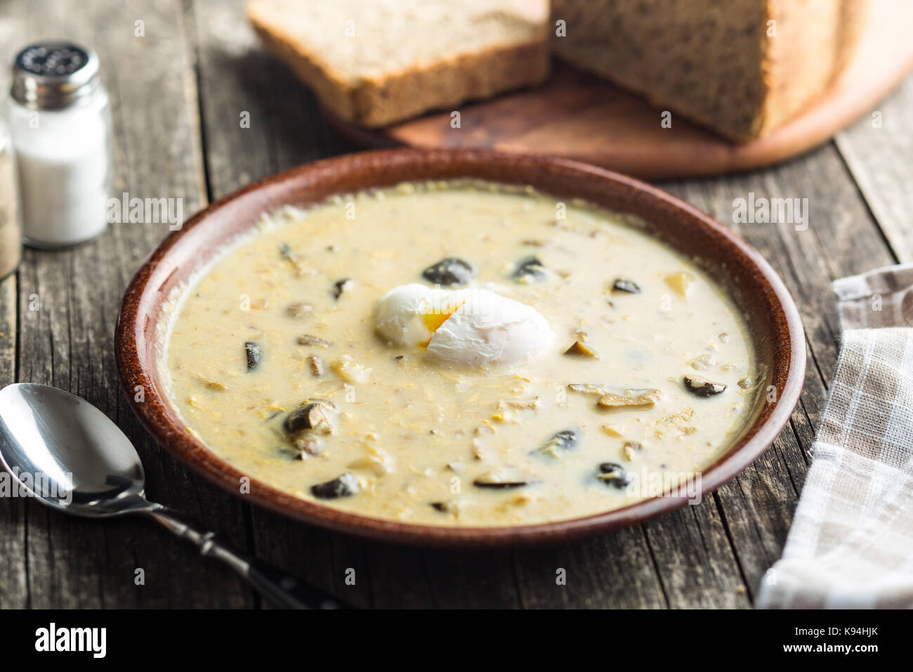 Cream of mushroom soup with poached egg. Stock Photo