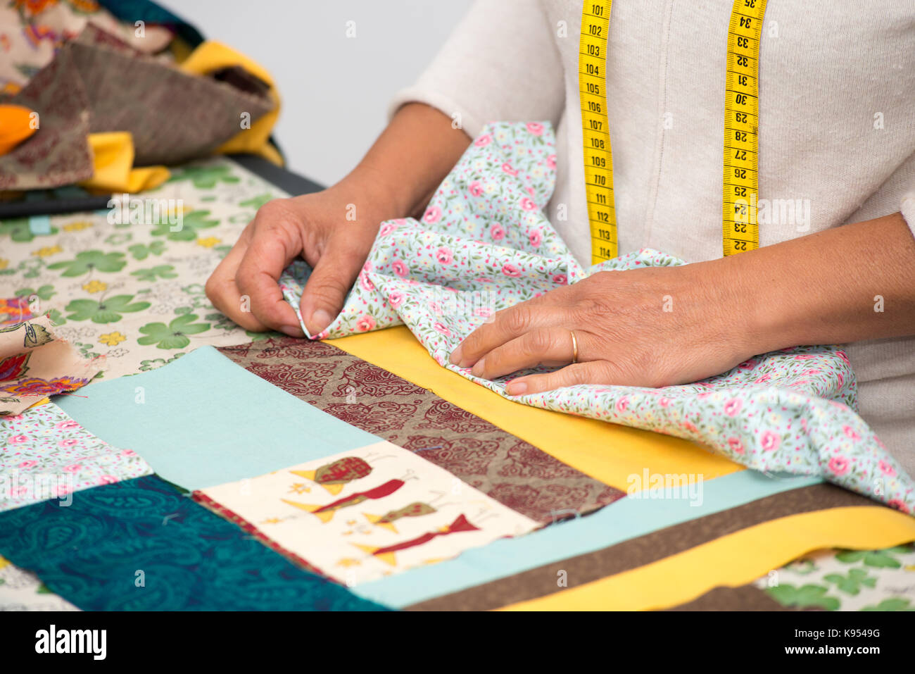 a close up of woman's hand sewing patchwork Stock Photo Alamy