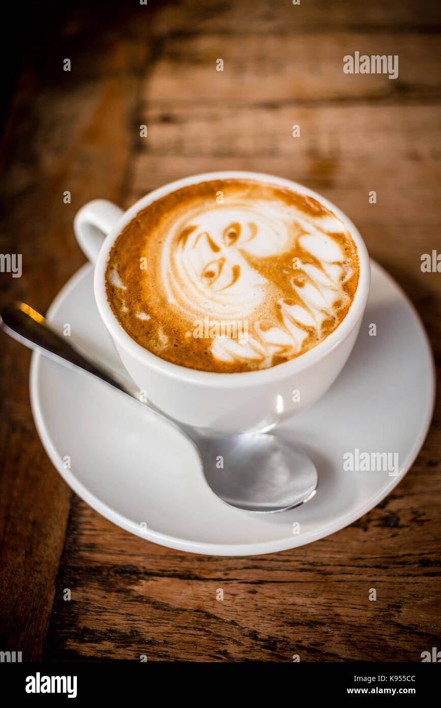 Coffee latte art on vintage table Stock Photo - Alamy