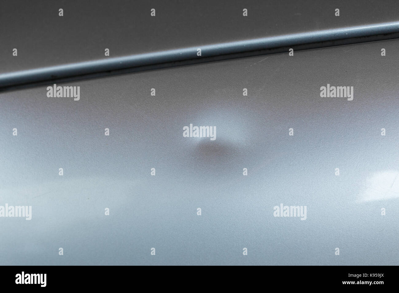 Bump on car with silver paint Stock Photo Alamy