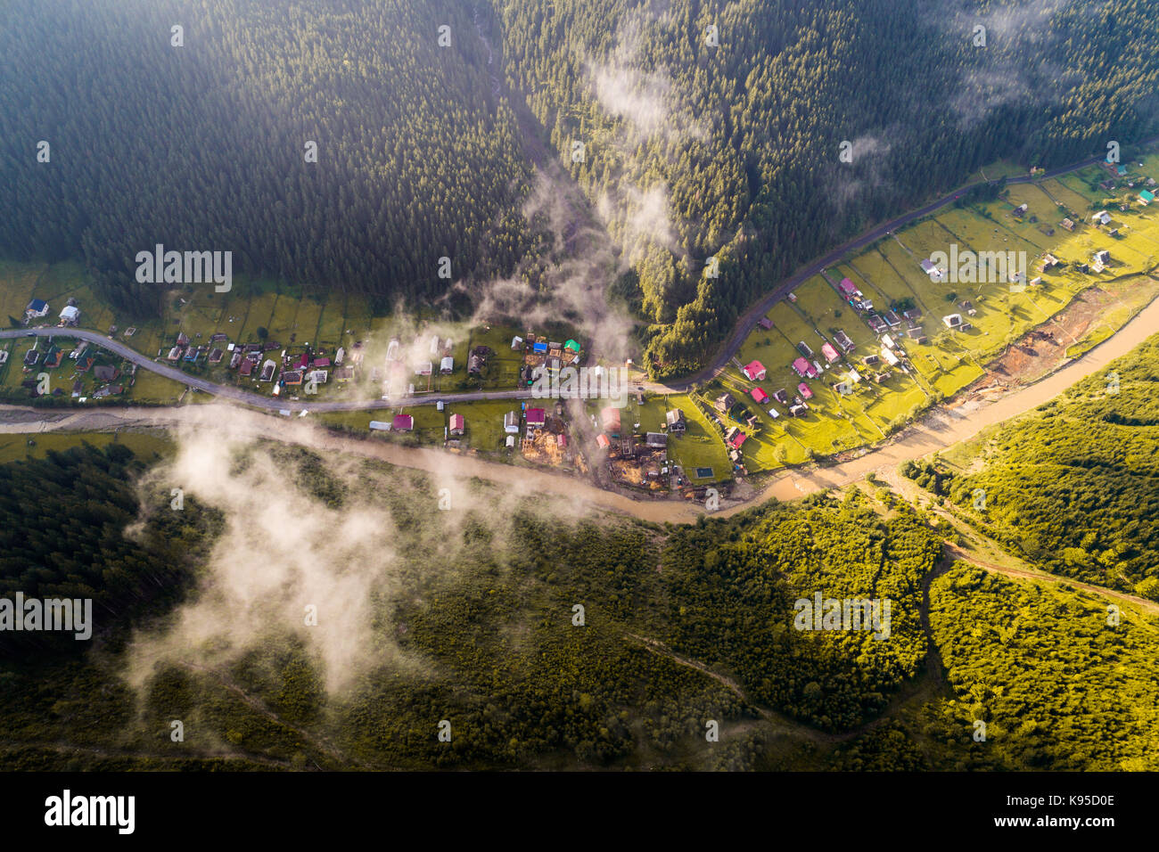 Aerial view of the village in the Carpathian mountains with clouds in ...