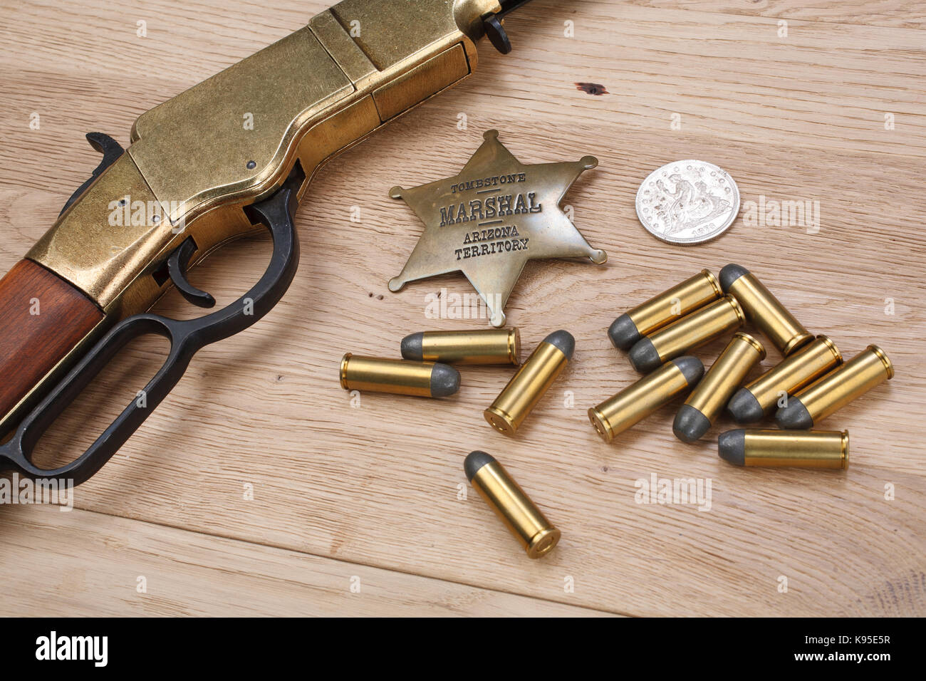Wild west period repeating rifle with ammunition and sheriff badge ...