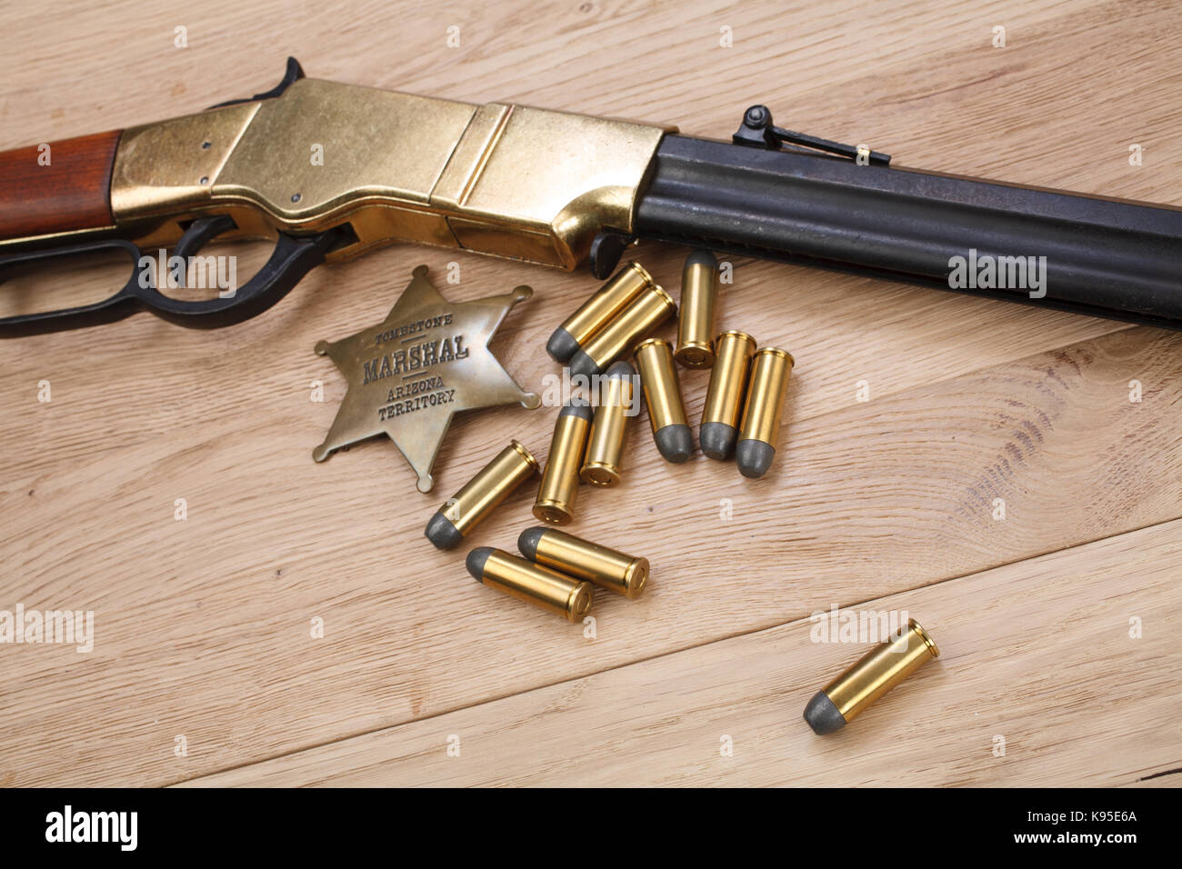 Wild west period repeating rifle with ammunition and sheriff badge ...