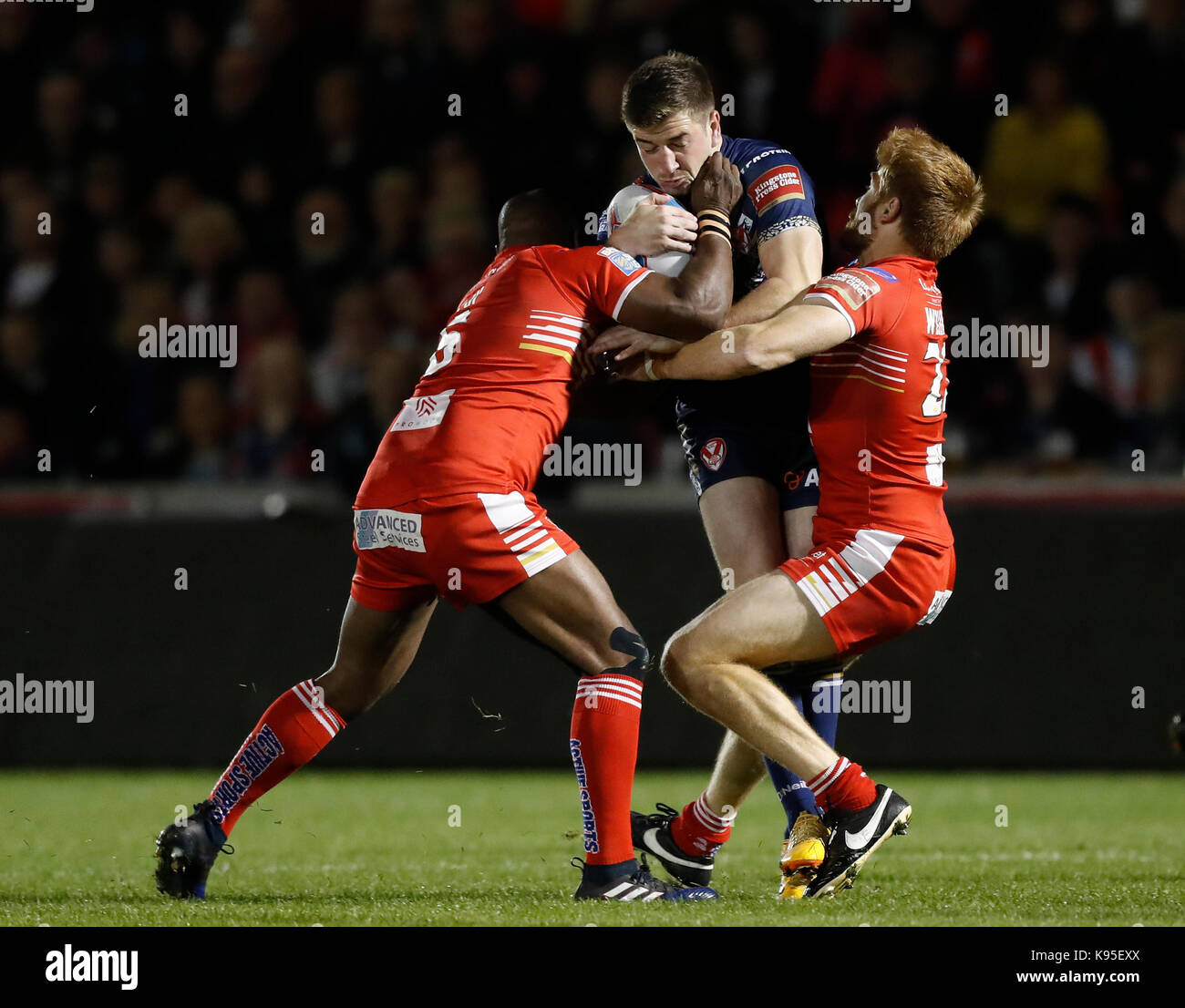 St Helens Mark Percival is tackled by Salford Red Devils' Rob Lui (left) and Kris Welham (right), during the Betfred Super 8s match at the AJ Bell Stadium, Salford. Stock Photo