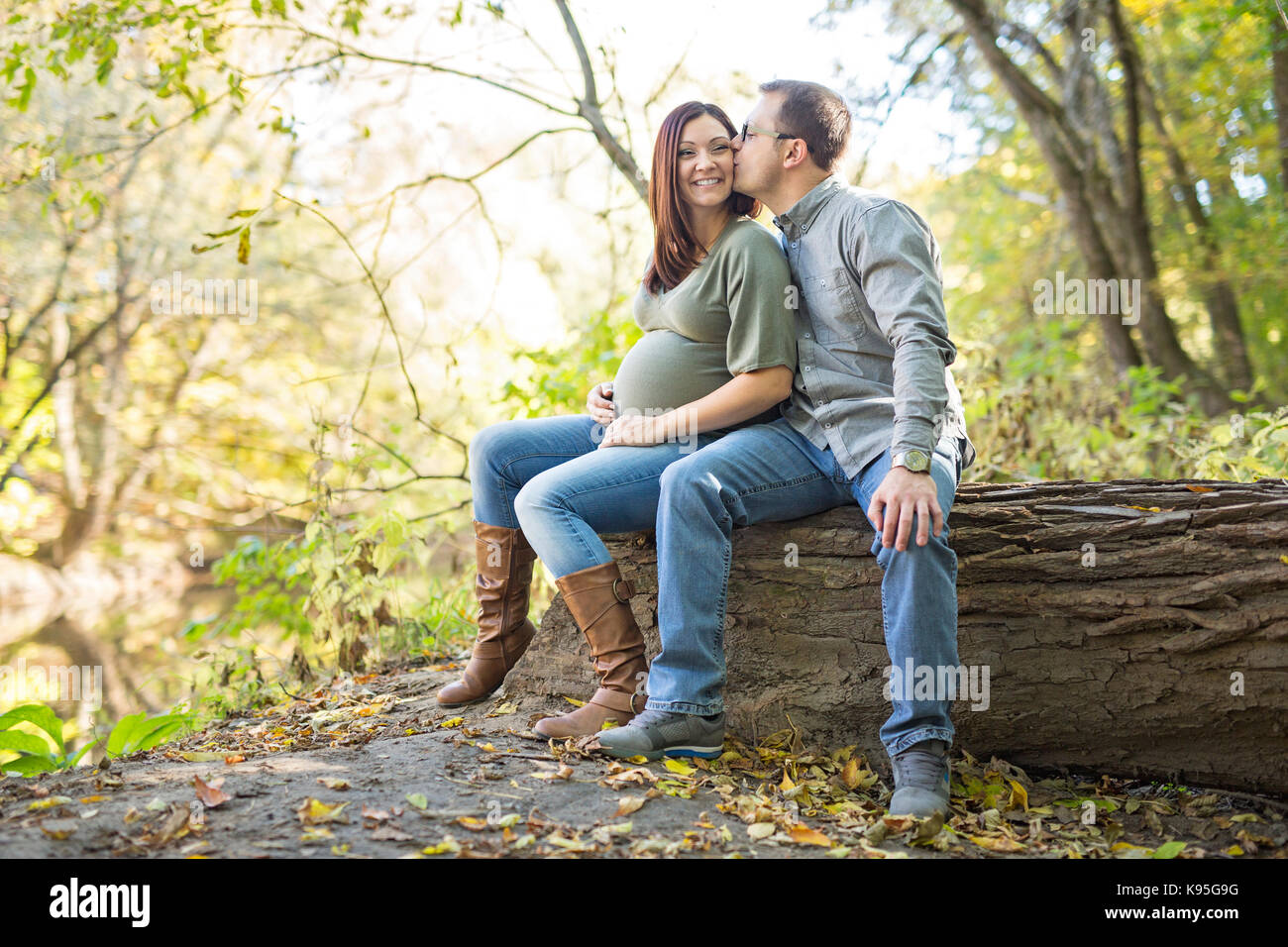 Beautiful pregnant couple relaxing outside in the park Stock Photo - Alamy