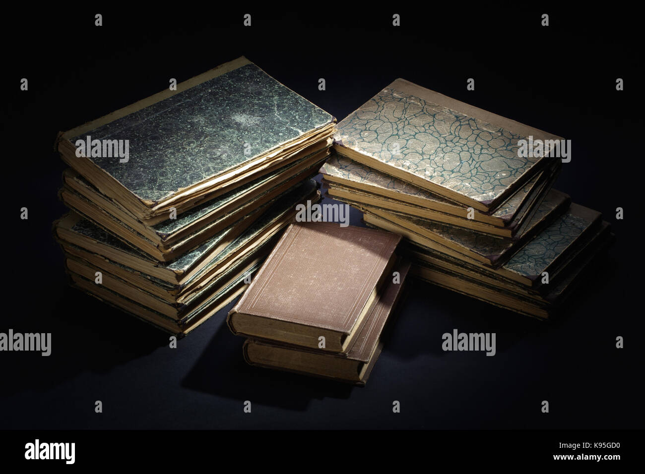 old books, papers, ink pen and inkpot on black background Stock Photo