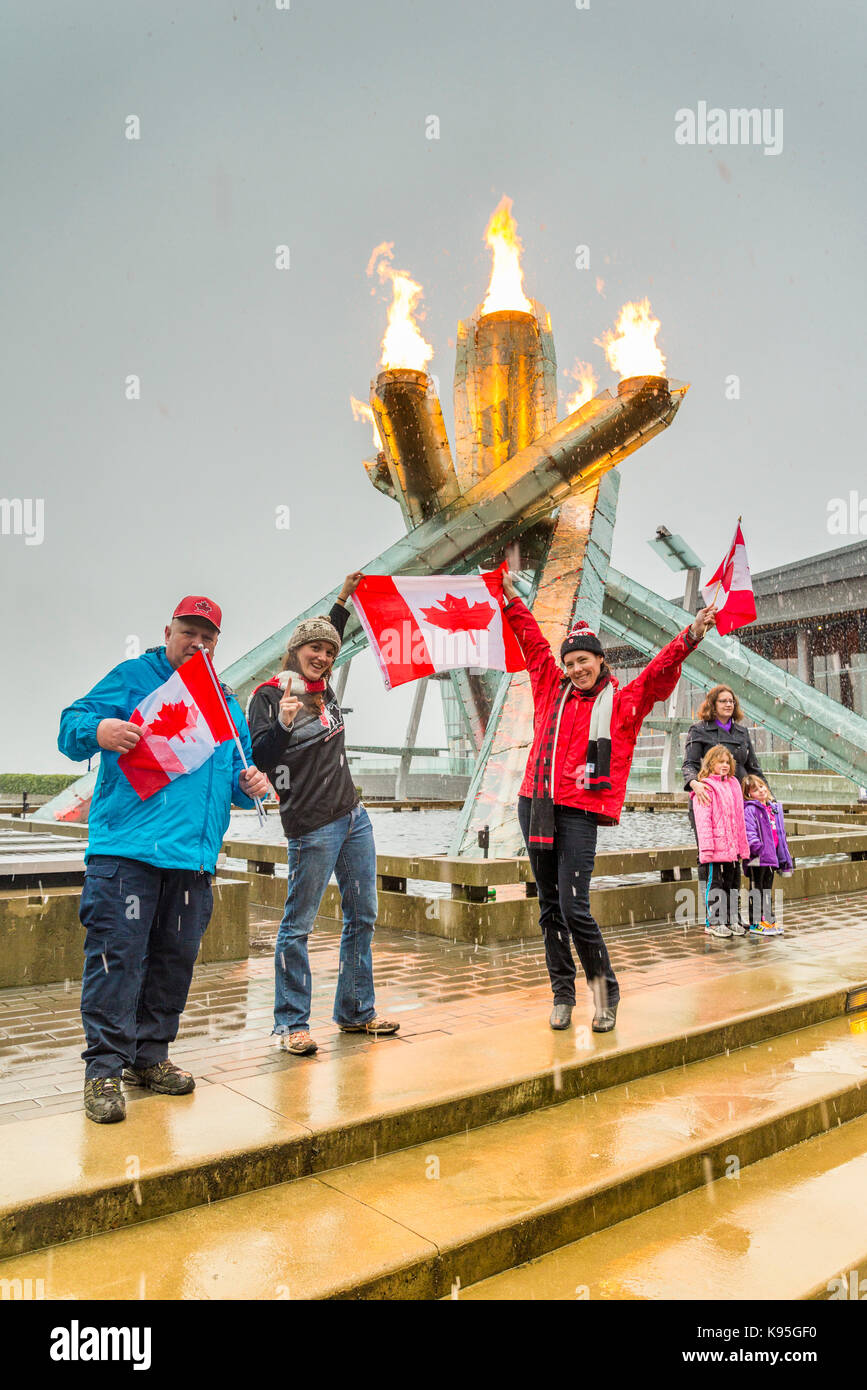Canadians celebrate the 2014 Olympic Hockey Mens and Womens gold medals by gathering at the 2010 Olympic Cauldron in Vancouver. Stock Photo
