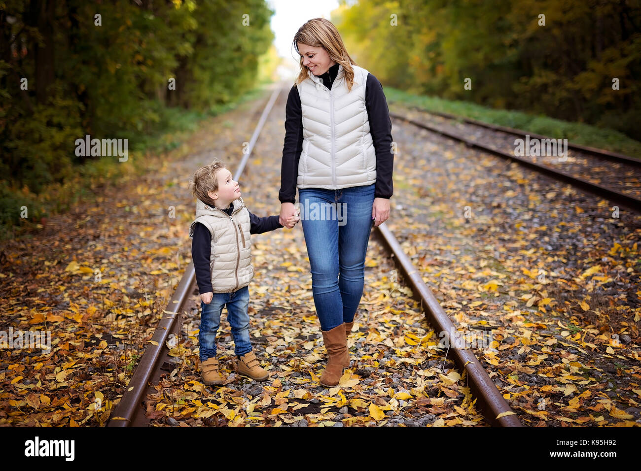 Adorable little boy with his mother in autumn park Stock Photo - Alamy