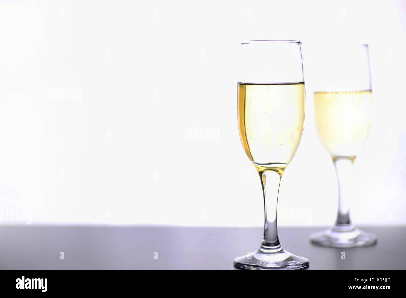 glass of white wine on a table on white background isolate Stock Photo ...