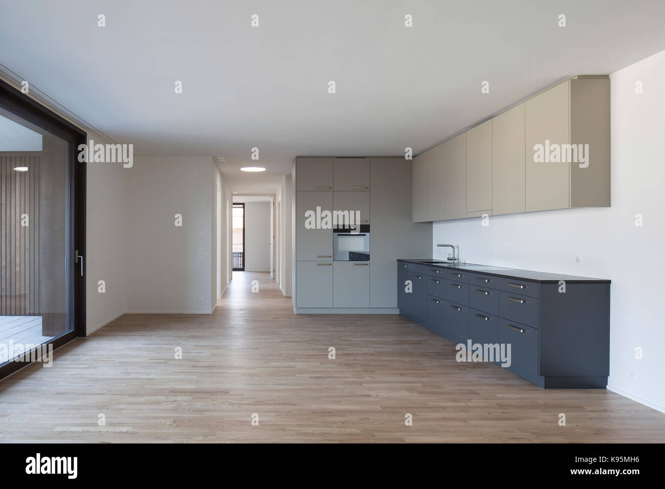 Unfurnished kitchen and corridor. Housing estate Malters, Malters, Switzerland. Architect: Diener & Diener, 2016. Stock Photo
