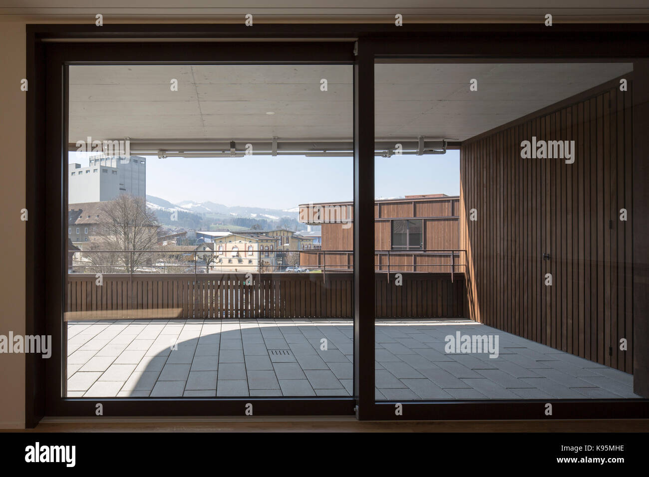 View through to balcony. Housing estate Malters, Malters, Switzerland. Architect: Diener & Diener, 2016. Stock Photo