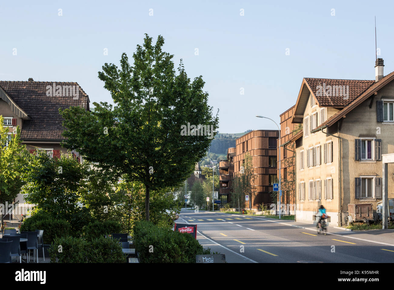 Contextual view with street. Housing estate Malters, Malters, Switzerland. Architect: Diener & Diener, 2016. Stock Photo
