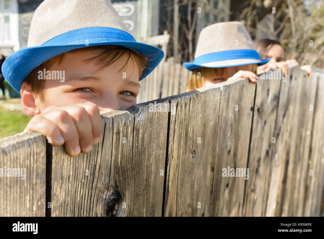 Cute country boy sitting on a fence Stock Photo - Alamy