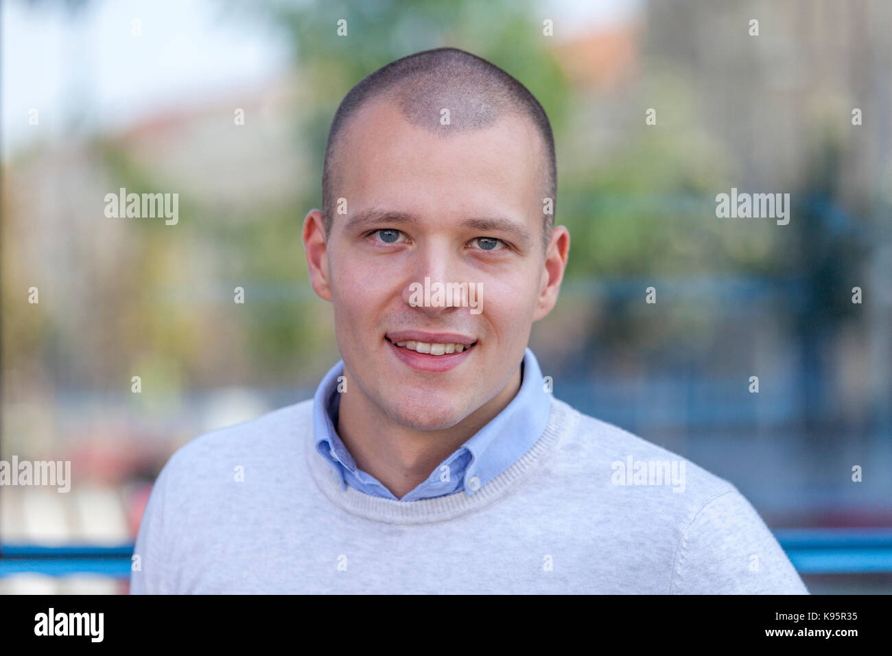 Close up portrait of handsome young businessman smiling by building in ...