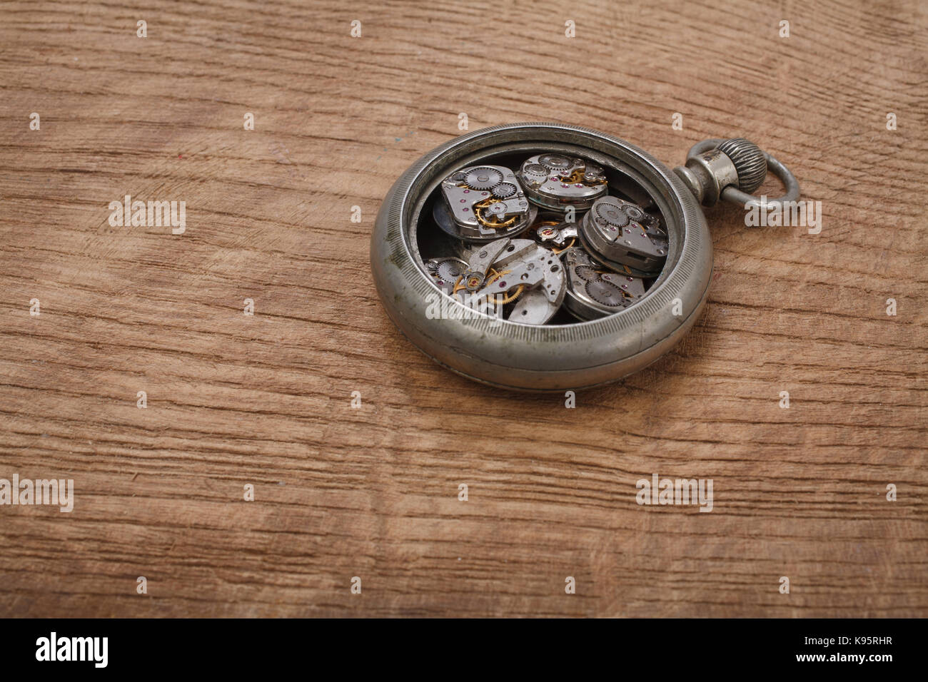 broken vintage pocket watch on wooden background Stock Photo Alamy