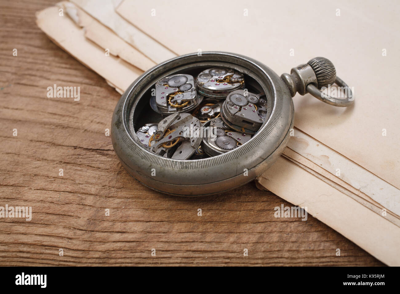 broken vintage pocket watch on wooden background Stock Photo Alamy