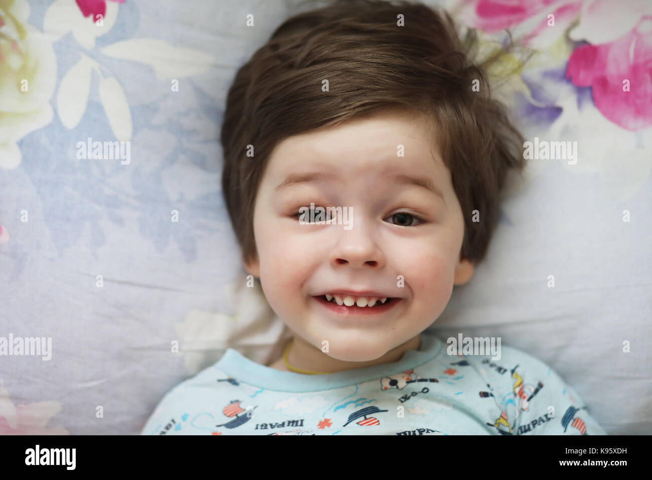 Portrait of a young child lying on a pillow Stock Photo Alamy