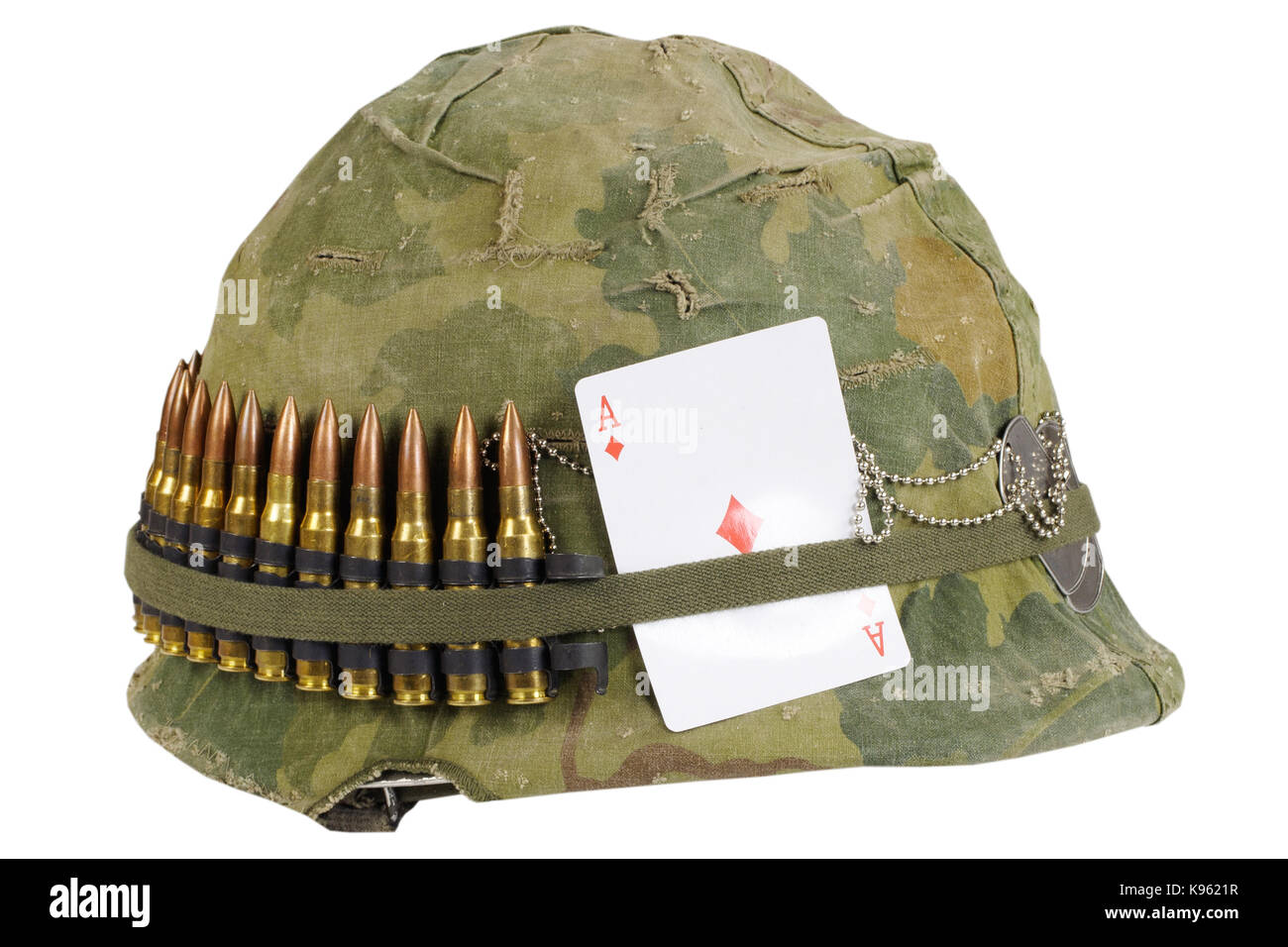 US Army helmet Vietnam war period with camouflage cover and ammo belt, dog tag and amulet - playing card ace of diamonds Stock Photo