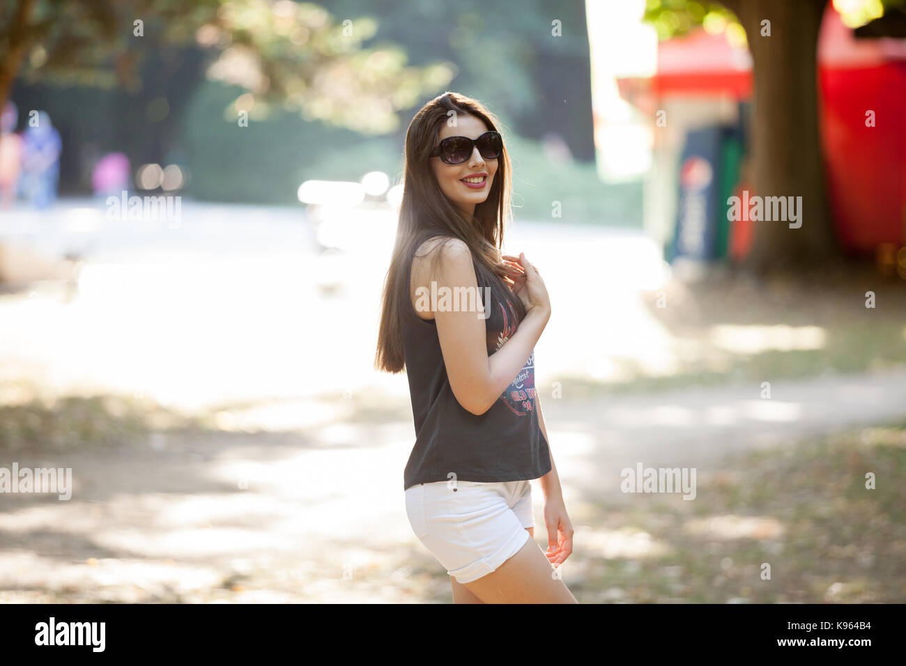 Pretty young woman posing in the park Stock Photo - Alamy