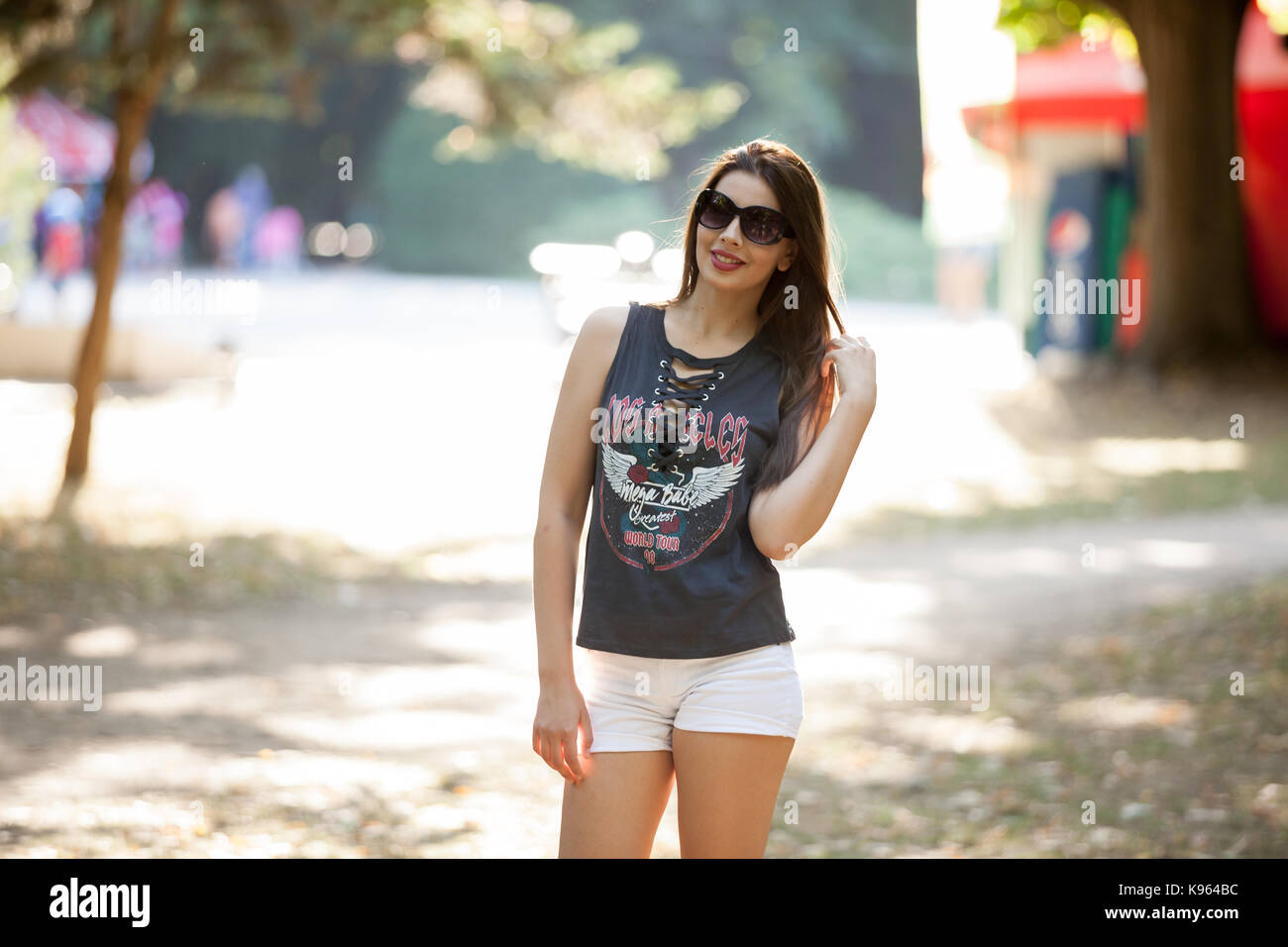 Pretty young woman posing in the park Stock Photo - Alamy