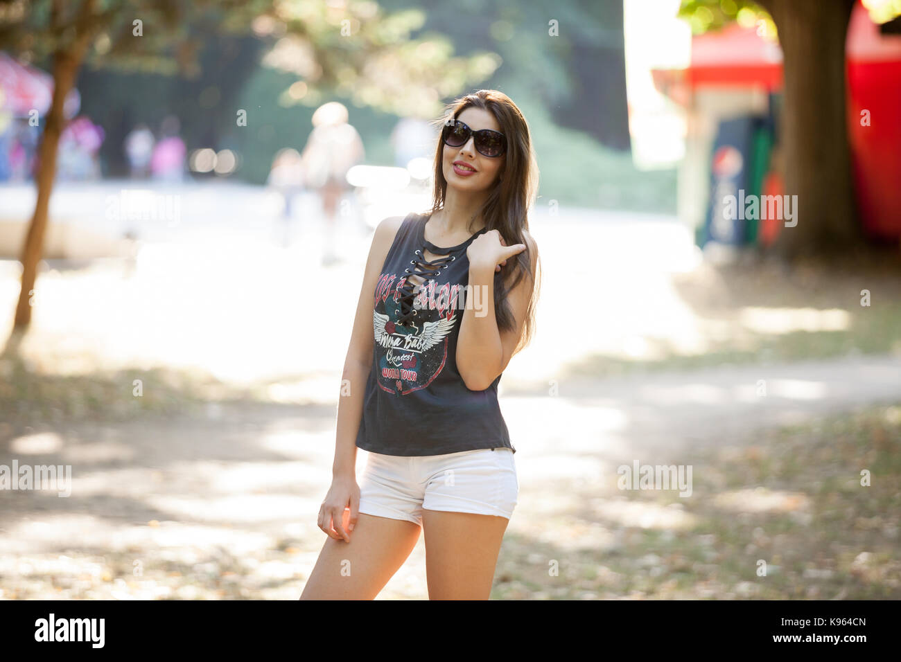 Pretty young woman posing in the park Stock Photo - Alamy