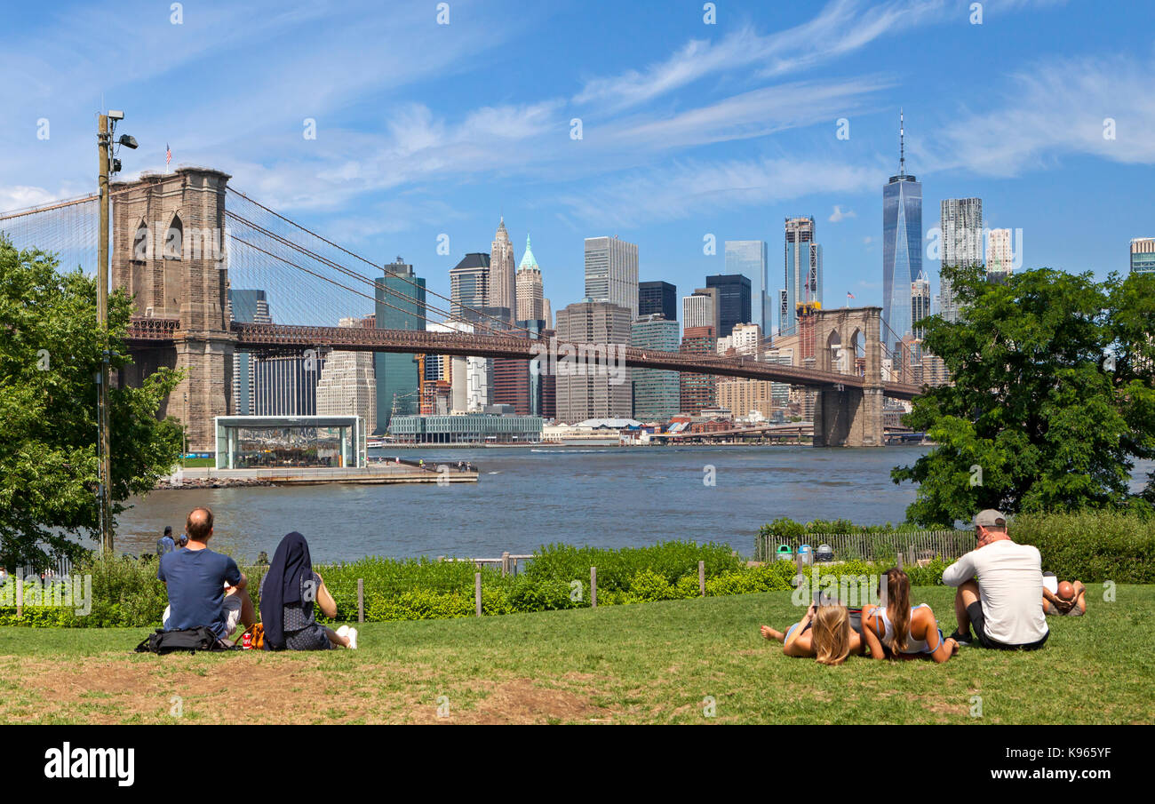 People walking, sitting and relaxing in the Brooklyn Bridge Park in Brookly, New York. Stock Photo