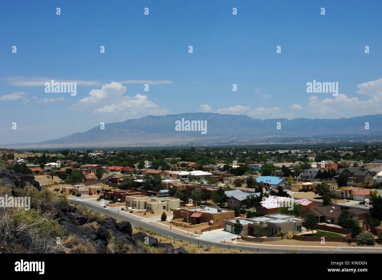 Overlook from the Petroglyph National Monument shows neighborhoods in Albuquerque and the distant Sandia Mountains. Stock Photo