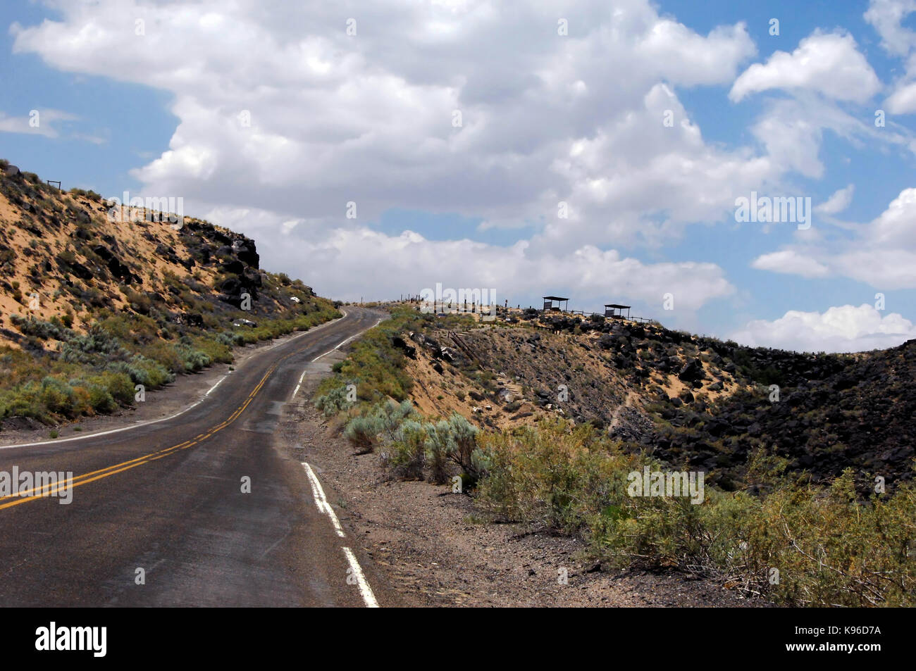 Road curves around the Petroglyph National Monument in Albuquerque, New Mexico. Stock Photo